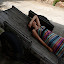 Paige not caring.. relaxing on an old wheel-barrow