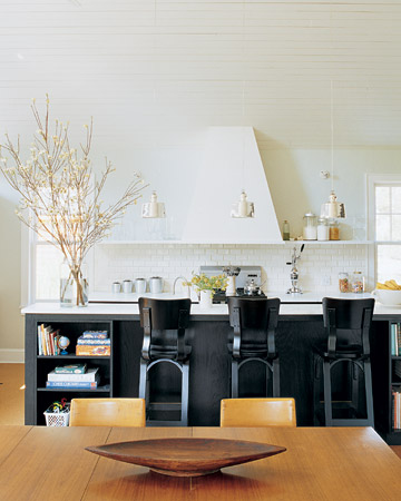 Black doesn't have to be heavy. This kitchen is bright and airy, but the black-painted island and chairs give it a central focus. Black doesn't have to be heavy. This kitchen is bright and airy, but the black-painted island and chairs give it a central focus.