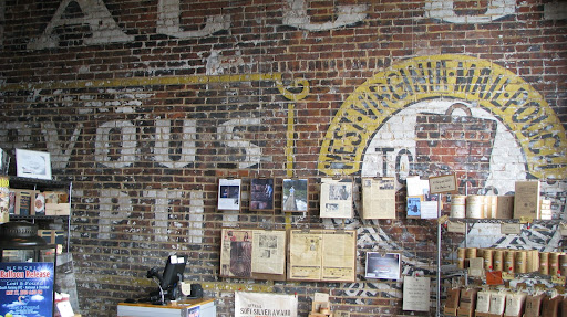 An old mural remains as it has been for generations, giving even more flavor to the atmosphere inside Askinosie Chocolate. (Photo credit: Kenrick Nobles)