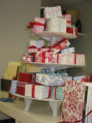 A tiered pedestal held neatly wrapped gifts.
