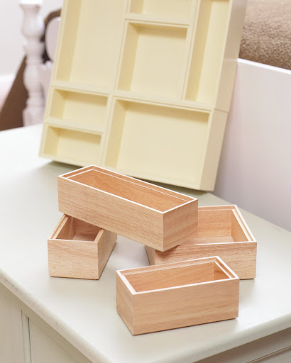 Kitchen drawer organizers can be painted and glued together for a custom tray to hold desk supplies.