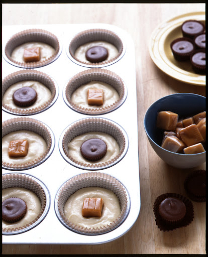 Add candy pieces to the centers of cupcakes. Fill liners half way with batter then drop in your favorite candies. Cover with remaining batter and bake as usual. Add candy pieces to the centers of cupcakes. Fill liners half way with batter then drop in your favorite candies. Cover with remaining batter and bake as usual.
