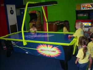 Penguins enjoying a game of air hockey!