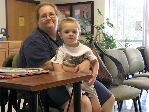 Kaston Yurich sits in the clinic waiting room with his grandmother, Cindy Hamilton. (Photo by: Kenrick Nobles)