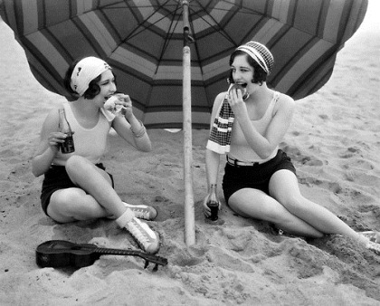 24th March 1927: American actress Joan Crawford (1904 - 1977) enjoys a picnic on the beach with fellow actress Dorothy Sebastian, left (1906 - 1957).