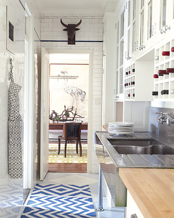 I like how this white kitchen is anything but sterile and cold, thanks to a runner and a fun bull's-head sculpture.