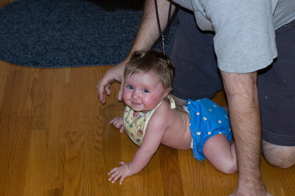 She can't quite get the crawling thing but she's close.