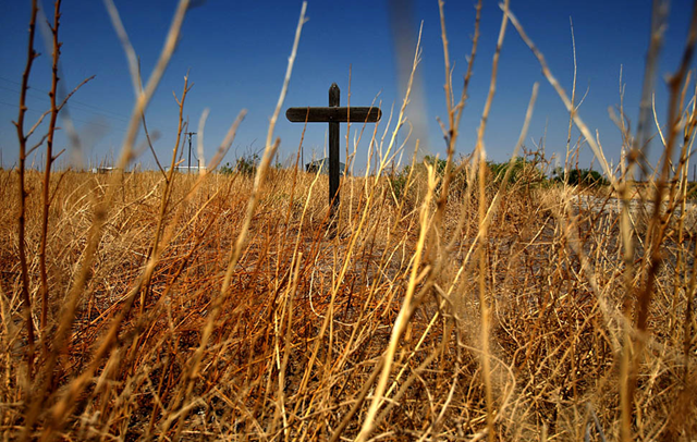 Verhalen, Texas &mdash; Dry weeds surround a wooden cross in a field near the town of Verhalen, 21 May 2011. The state is suffering from a severe drought that is causing wildfires and hardship for ranchers and farmers. PHOTOGRAPH BY: Genaro Molina / Los Angeles Times