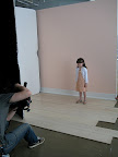 Nico on set, modeling the sequin cardigan.