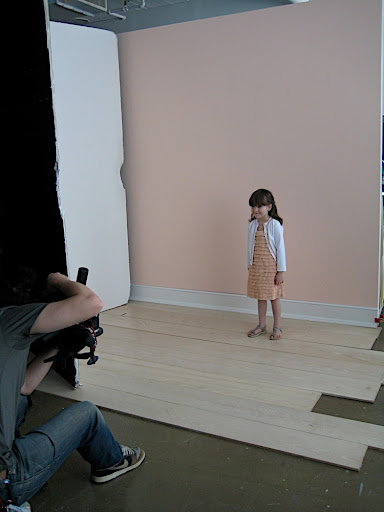 Nico on set, modeling the sequin cardigan.