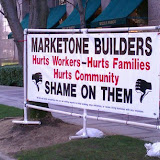 Demonstrators were out Monday morning in front of 400 Capitol Mall with a large banner stating "HINES, hurts workers, hurts families, hurts community. SHAME ON THEM!". They have also erected a large grim reaper looking effigy in a black shroud and skull faced. News_110307_HinesDemonstration