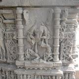 Vaishnavi, can be identified by the mount, Garuda, standing at the base, left to the goddess. Much of the image is ruined by now so only identification via mount is possible.