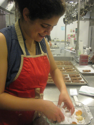 Here I am tossing cooled sandies in powdered sugar.