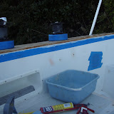 Applying sealant underneath the teak coaming.  There was a huge gap due to the hold sealant having falled apart.