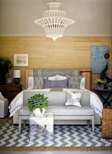 Grass cloth walls warm up a Nantucket-inspired bedroom. The acrylic table is even outfitted with rope handles to add nautical flair to an otherwise modern piece. Grass cloth walls warm up a Nantucket-inspired bedroom. The acrylic table is even outfitted with rope handles to add nautical flair to an otherwise modern piece.