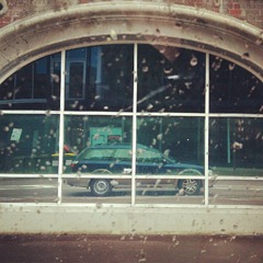 Reflection of our car in the windows of the Horse Shoe Bridge