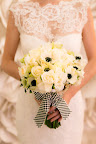 The New York state flower (roses) was included in the bouquet wrapped by a black and white checkered ribbon insipired by checkered cabs. Bouquet by Matthew Robbins. At the end of the evening, the bride tossed the bouquet and the  girl who caught it won dinner for two at the classic New York restaurant Le Cirque.