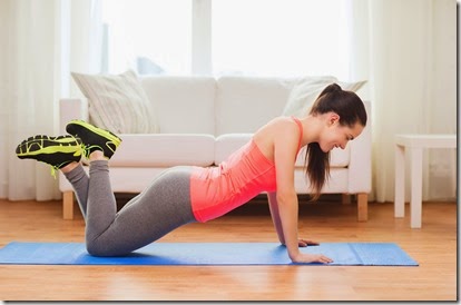 fitness, home and diet concept - smiling teenage girl doing push-ups at home