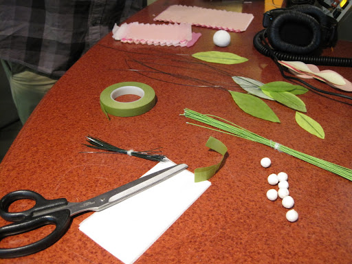 At minimum, you need scissors, crepe or tissue paper, wire, and floral tape. Leaves for the stem and pearl balls for the center of the blossoms make nice touches as well.