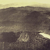 An aerial view from the NNW shows the two summit craters of Gunung Patuha volcano in the foreground. Steep-walled Taman Saat crater (left) is located NW of lake-filled Kawah Putih (right). The dashed circle at the middle left marks the Tugeslibde crater.<br />
Photo published in Taverne, 1926 "Vulkaanstudien op Java," (courtesy of Volcanological Survey of Indonesia). An aerial view from the NNW shows the two summit craters of Gunung Patuha volcano in the foreground. Steep-walled Taman Saat crater (left) is located NW of lake-filled Kawah Putih (right). The dashed circle at the middle left marks the Tugeslibde crater.<br />
Photo published in Taverne, 1926 "Vulkaanstudien op Java," (courtesy of Volcanological Survey of Indonesia).