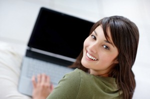 Attractive young female using a laptop