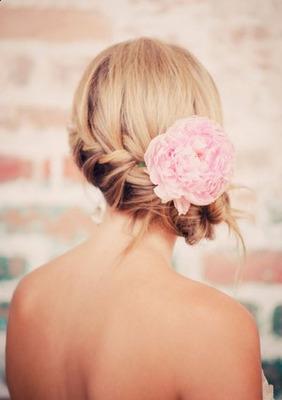 The pale pink camellia makes the perfect finish to this waterfall-braided updo