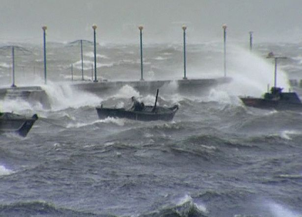 In this image made off North Korea's Korean Central News Agency video footage, a person rides on a small boat in the rough seas off Wonsan City in Kangwon Province, North Korea, as a typhoon hits the area on Tuesday, 28 August 2012. Two typhoons in less than a week 'brought big damage' to North Korea, killed 48 people, and displaced more than 20,000 people, Hundreds of trees were felled and power cut. AP Photo / Korean Central News Agency