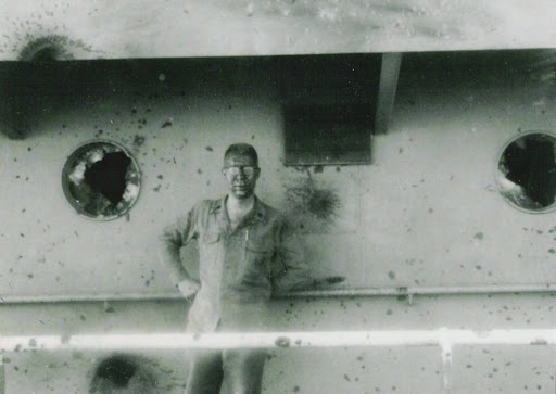 Marine Bryce Lockwood stands aboard the badly damaged USS Liberty after it was attacked on June 8, 1967.