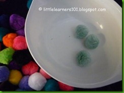 sorting grey pom poms