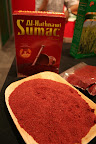 If za'atar is old hat for you, here's another Middle Eastern/North African spice to try: sumac.  It's the key to adding lemony flavor to many dishes, from everyday hummus to the Palestinian chicken dish Musakan.