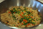 Cooked organic vegetables are added to the brown rice.