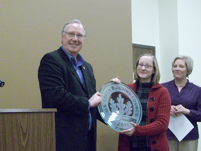 Bruce Hamous presenting the LEED Certified plaque to Director Debbie Stanton