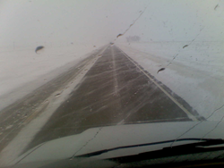 c0 snowy weather as seen through a car windshield.