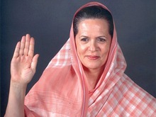 Mrs. Sonia Gandhi, leader of the Ruling Party of India, the Congress party, leader of the ruling coalition of India, United Progressive Alliance [UPA], but not the Prime minister of India. Heads the National Advisory Council [NAC]. Seen here, perhaps, blessing the country.