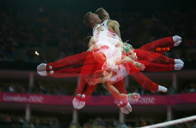 Denis Ablyazin of Russia competes in the horizontal bar event during the men's gymnastics qualification in the North Greenwich Arena during the London 2012 Olympic Games July 28, 2012. Picture taken with multiple exposures. REUTERS/Mike Blake