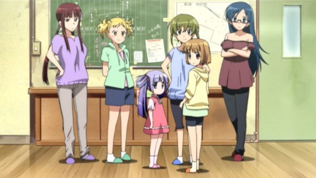 The primary cast standing in a line looking over in the viewer's direction
