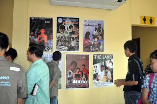 Audience view the advertisement poster designed by competing students.