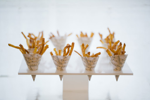 I scanned some strips of measuring tape ribbon from The Crafty Owl onto thick paper and they were used to wrap these mini french fry hors d'oeuvres by Peter Callahan Catering.