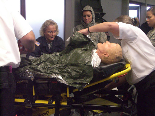 In the simulated medical prep room, doctors, nurses and medical techs prepare mock patients for the flight. (Photo credit: Jennifer Moore)
