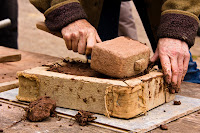Earth artist, Jill Smallcombe, demonstrated cob brick building using a mixture of subsoil, straw and water, Burrow Farm, near Drewsteignton, Dartmoor National Park, Devon, England, U.K.