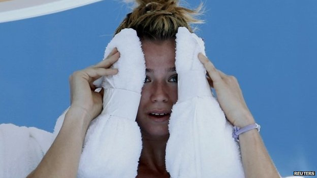 Camila Giorgi of Italy holds an ice towel to her face during her women's singles match against Alize Cornet of France at the Australian Open 2014 tennis tournament in Melbourne, 16 January 2014. Some matches were halted during the 2014 Australian Open after three consecutive days of temperatures over 40C (104F). Photo: Reuters