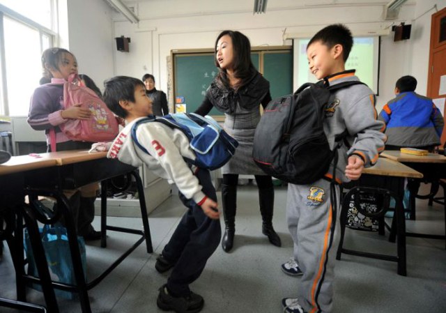 TOPSHOTS Chinese children get a feel what their mothers experienced during pregnancy, at a sex education class in Beijing on December 9, 2010.  Chinese health and education experts are changing China's sex education strategy from focusing on teaching married couples birth control, as unmarried young also need to be targeted because parents are too reluctant to teach their children about sex, while more than 13 million abortions are undertaken at registered clinics every year.            CHINA OUT        AFP PHOTO (Photo credit should read STR/AFP/Getty Images)
