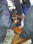 Nailing together parts to make a picnic table for Scouters' Mountain