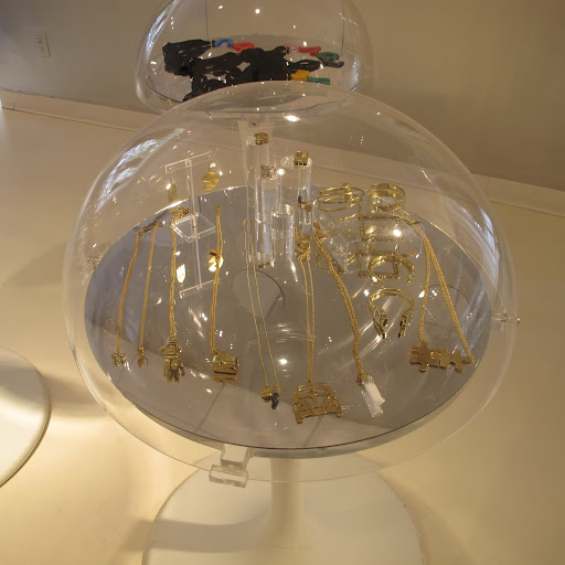 A selection of gilded jewelry. The domed display case is quite unique.