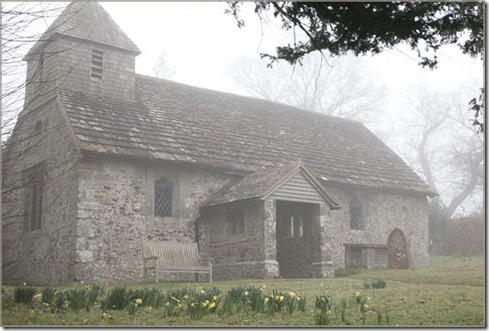 Old village church in fog