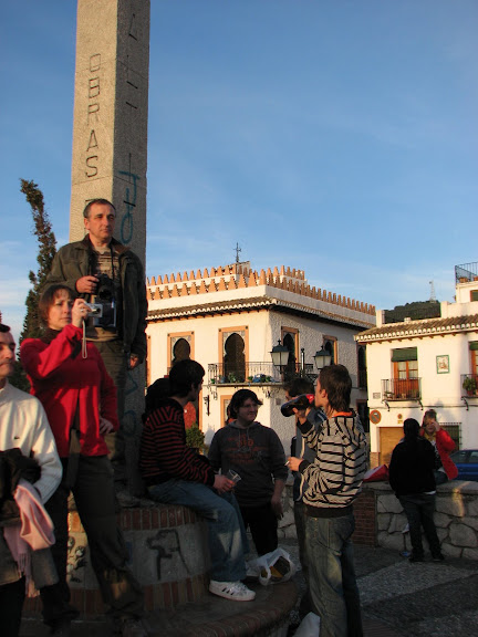 Tourists taking pictures and local kids just hanging out