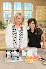 Martha and I posing in front of a table of our fabulous giveaways.