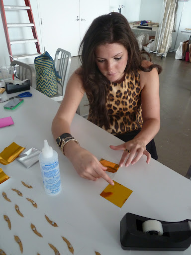And Colleen making the garlands. We used tape dispensers to keep the monofilament taut.
