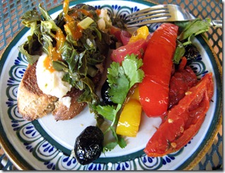 Capriata plate. That's puree of white beans on the bruschetta, topped with steamed chard. Peperonata and olives. Sauce on acelgas is a modified harissa.