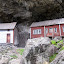 Very old wooden house built underneath the rocks at Helleren